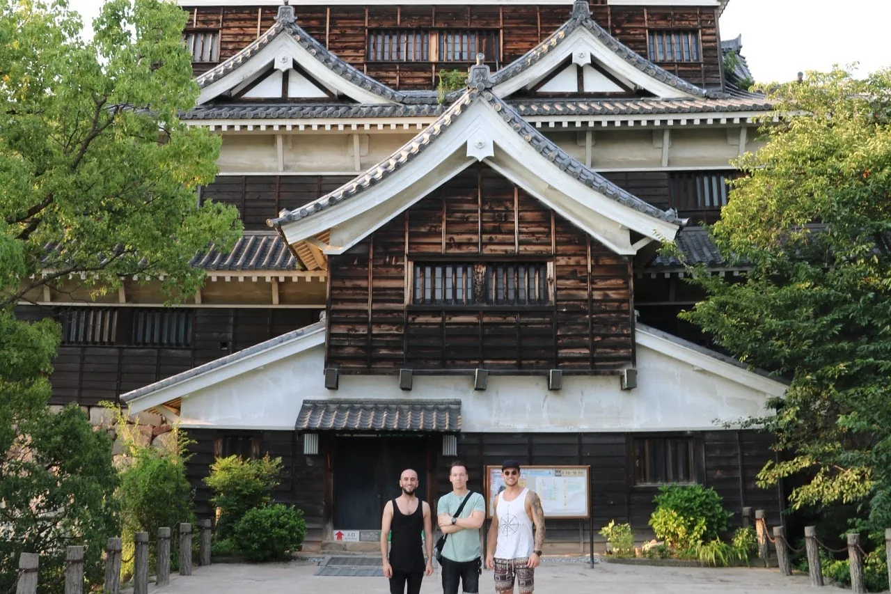 Three friends standing in front of Hiroshima Castle on our first trip to Japan in July 2017