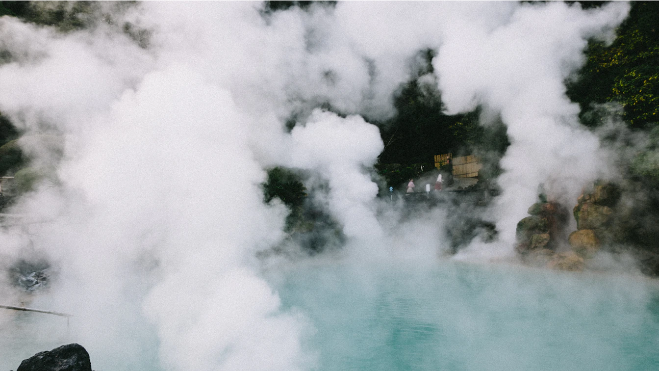 Visitors digging their own hot spring pools in the volcanic sand at Sunayu beach in Beppu