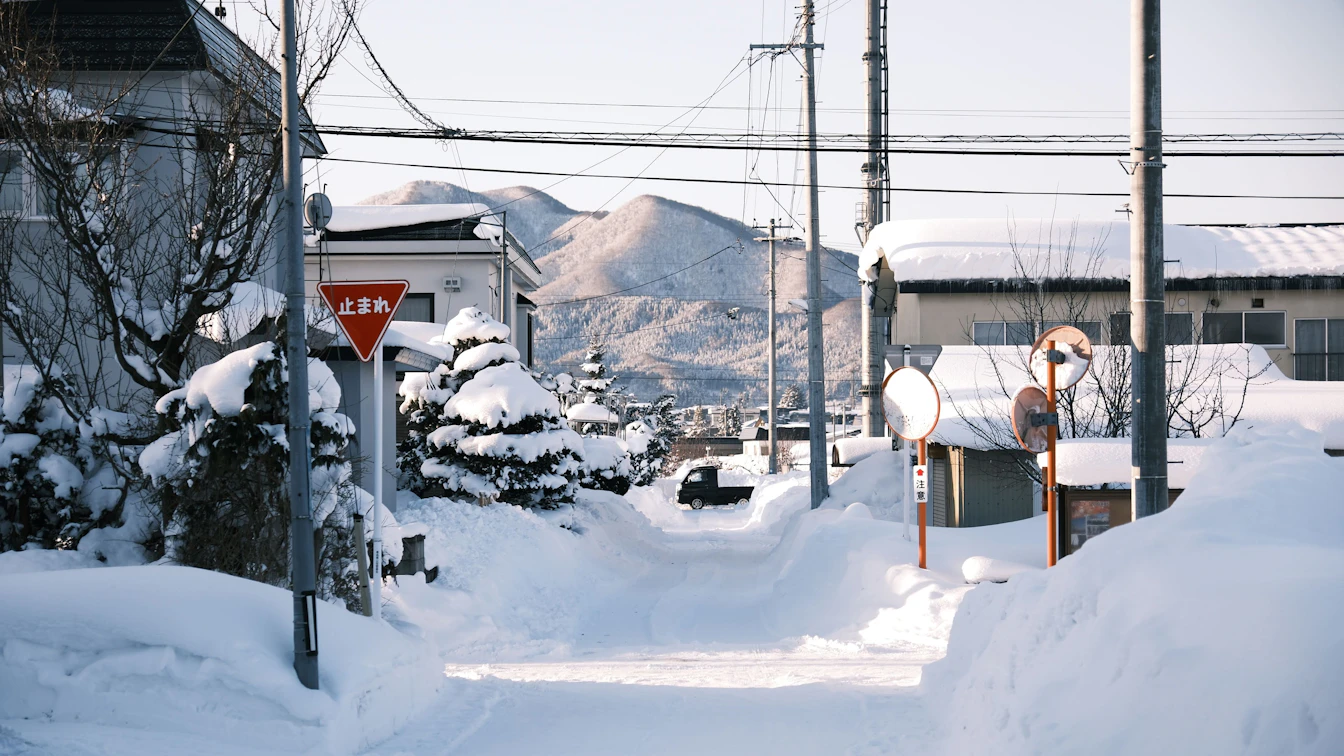 Traditional mixed bathing outdoor pool at Tsurunoyu Onsen surrounded by snow-covered mountains
