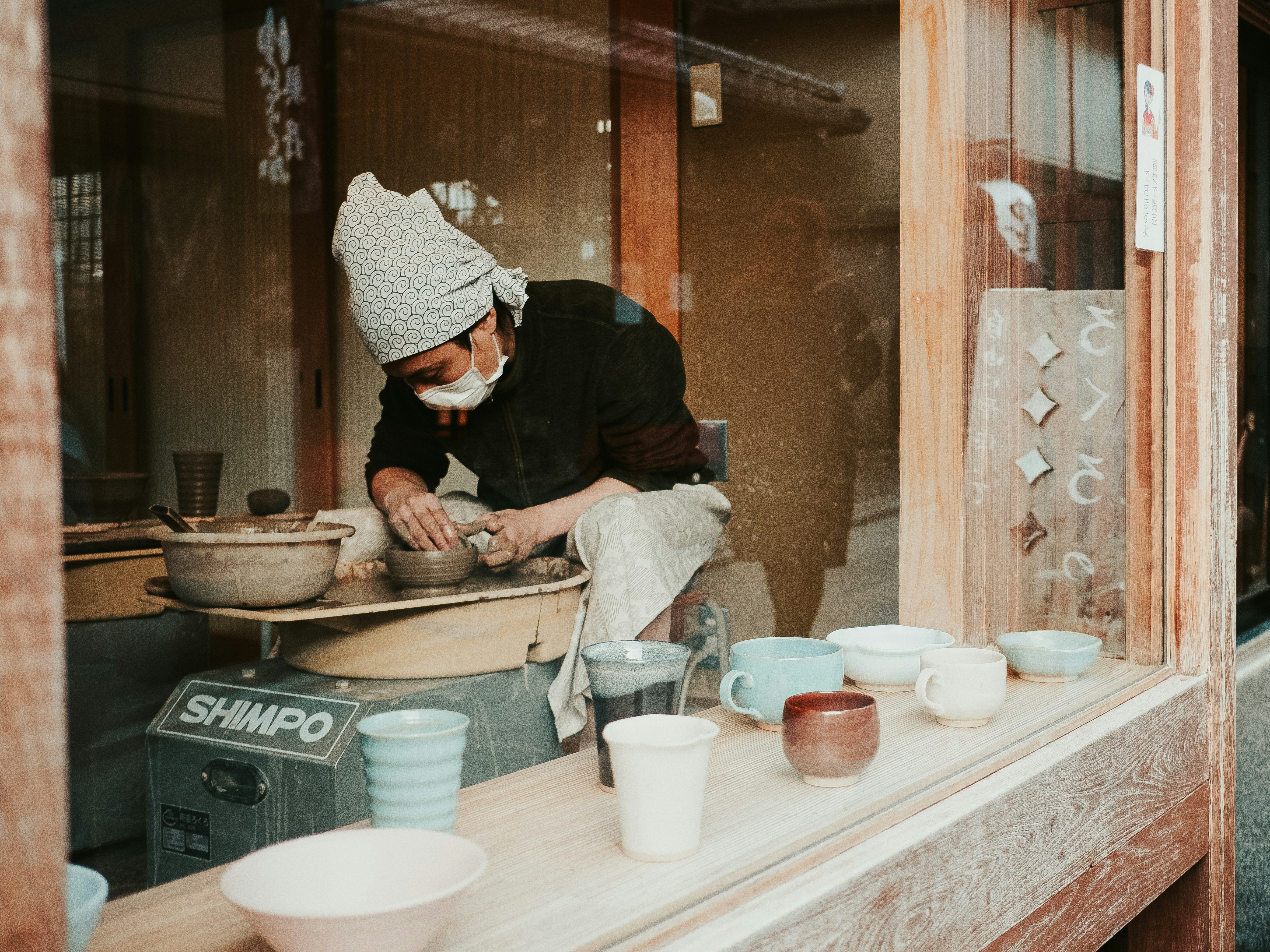 Hands shaping a bowl on the wheel in a Mashiko studio