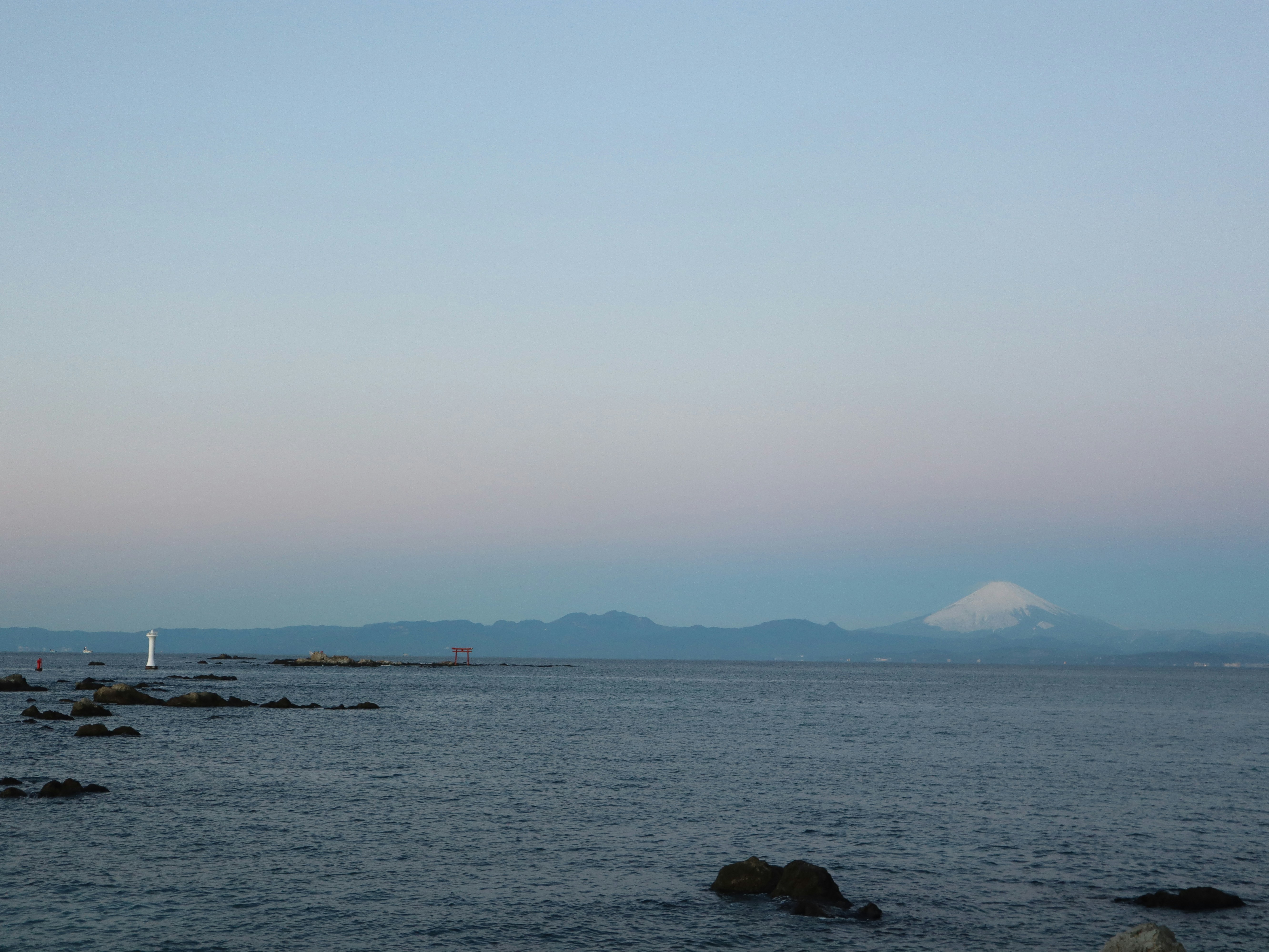 The torii of Morito Daimyojin Shrine standing on a rock in the sea at Hayama
