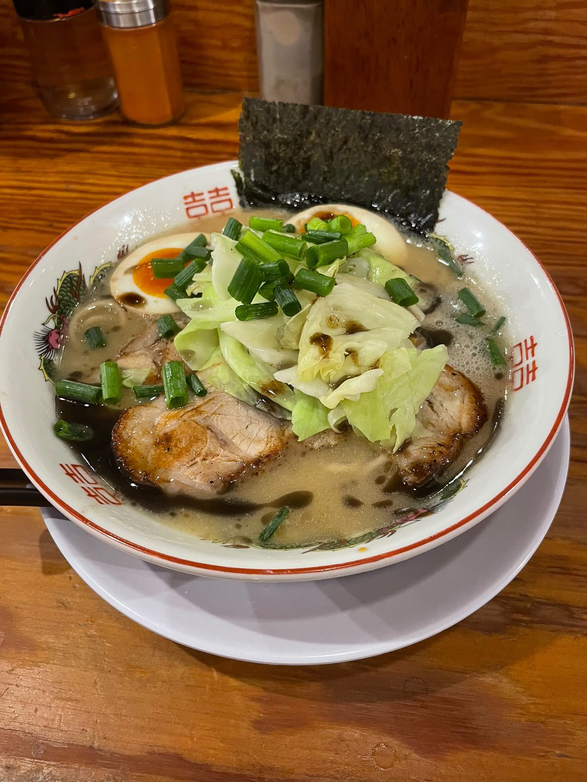 Bowl of Fuji Ramen Masterpiece tonkotsu — pale silky broth, shredded cabbage, chashu, marinated egg, nori