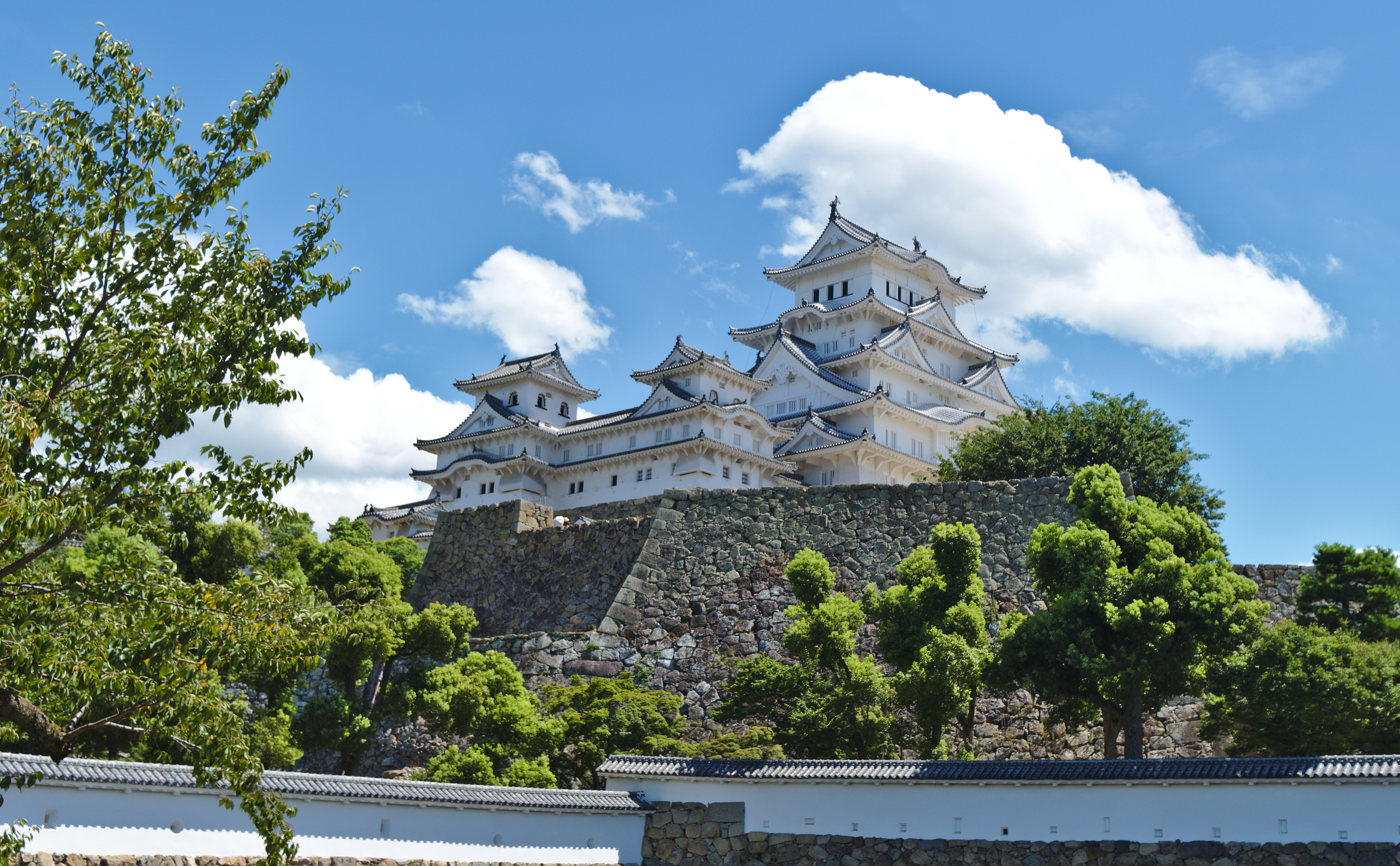 The white keep of Himeji Castle seen along its walled approach path