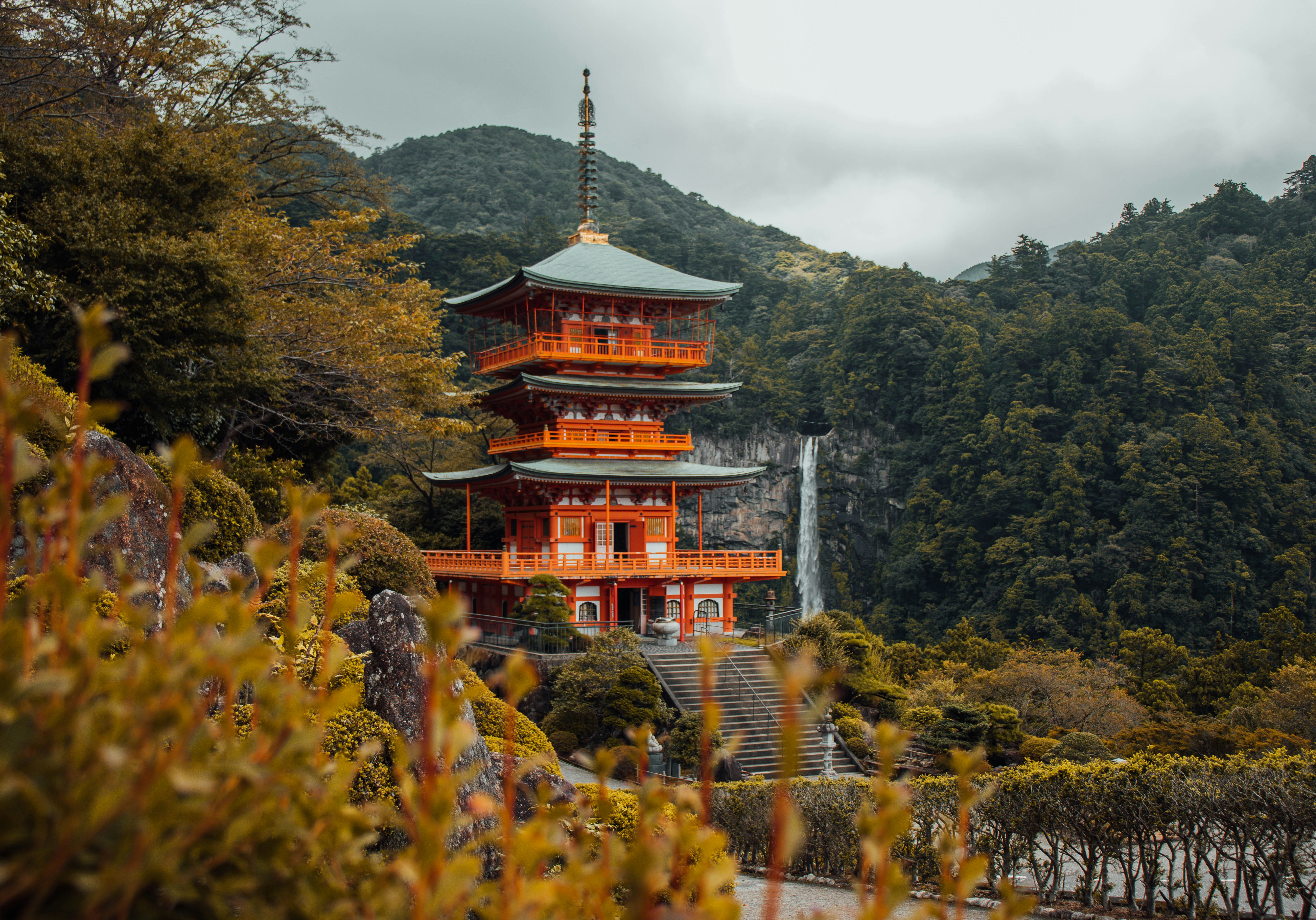 The vermilion pagoda at Kumano Nachi Taisha with Nachi Falls behind it