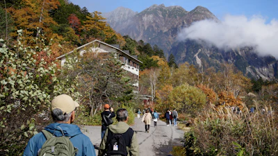 Kamikochi alpine valley with wooden suspension bridge and Northern Alps peaks