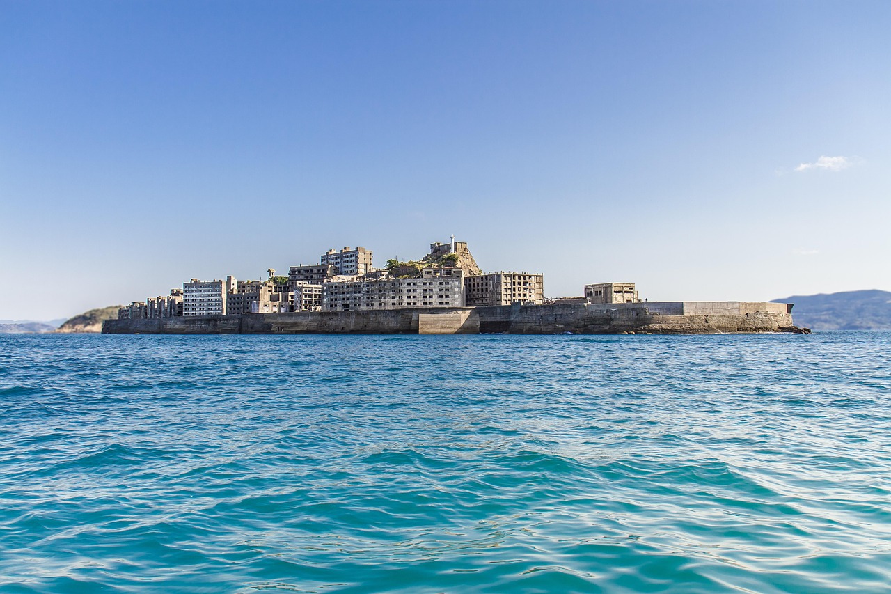 Gunkanjima seen from the water, its seawall forming a battleship profile