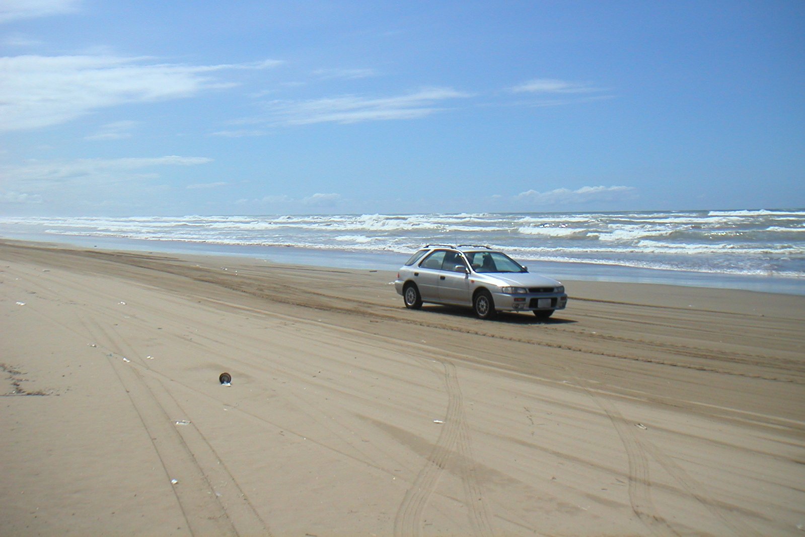 Car driving on the sand of Chirihama Nagisa Driveway