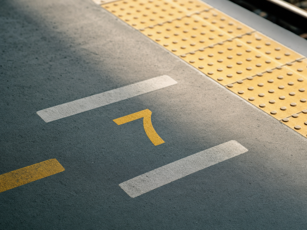 Shinkansen platform with numbered car-position markers on the floor