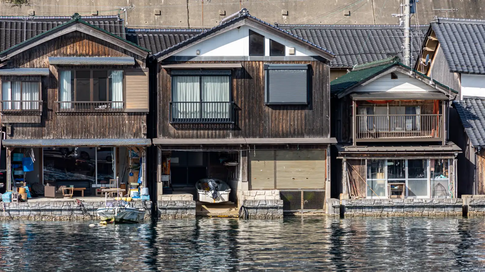 Wooden funaya boathouses lining the curve of Ine Bay
