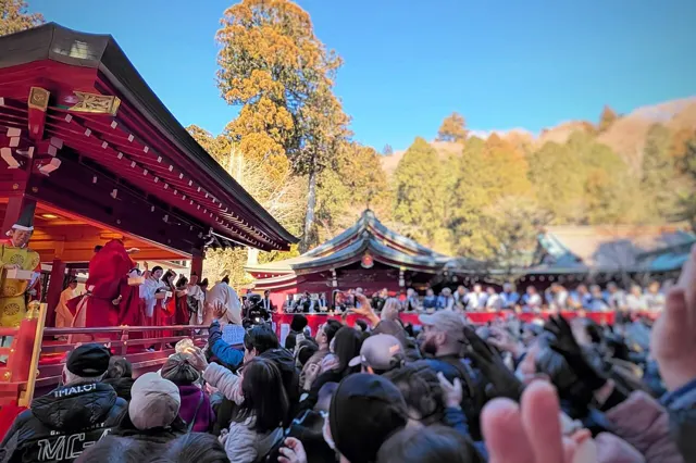 Crowds catching beans at a Setsubun ceremony at Hakone Shrine