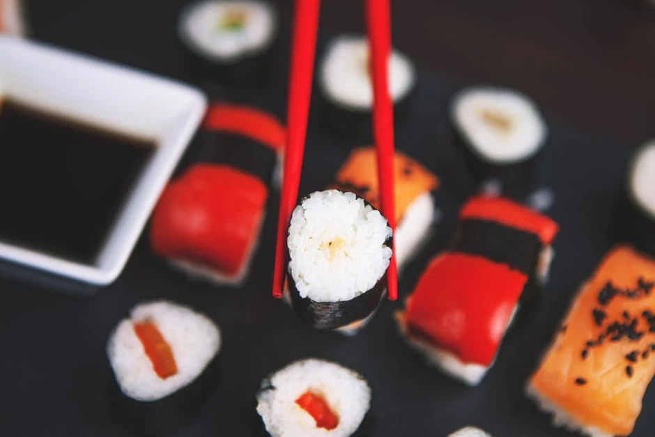 Fresh nigiri sushi on a wooden board at a Japanese sushi counter
