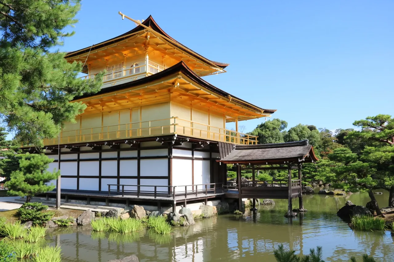Kinkaku-ji, the Golden Pavilion, mirrored in its pond on a summer morning