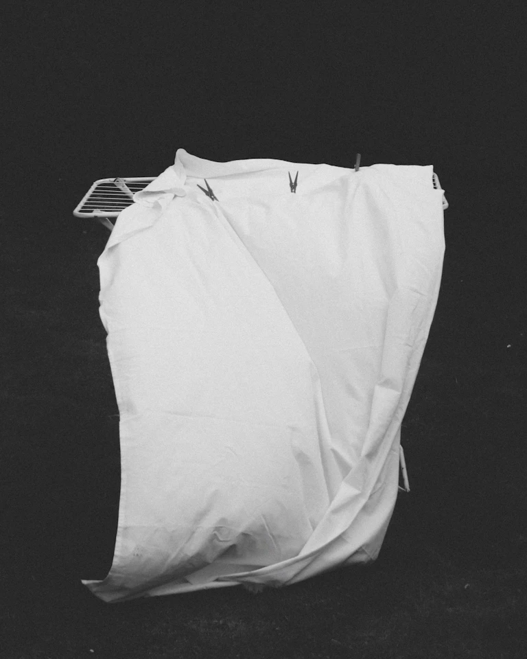 Visitor in white clothing with digital projections